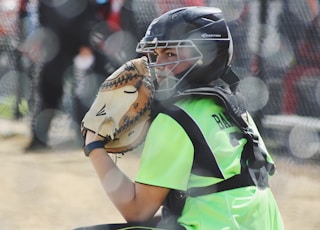 woman wearing brown Easton baseball mitt playing baseball