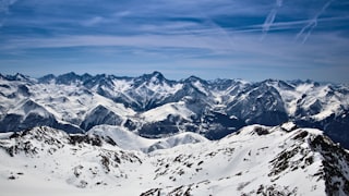 Snowy alpine peaks seen from a high ridge