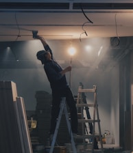 man on white ladder