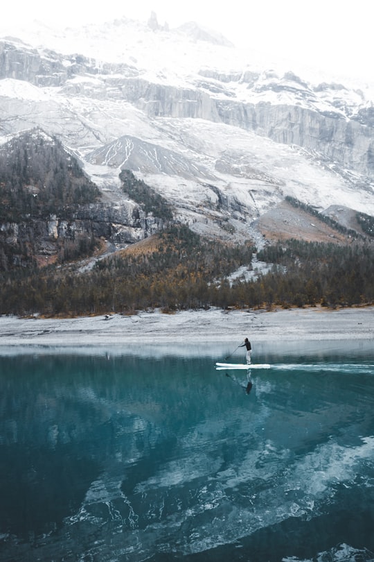 person doing paddle board in Oeschinen Lake Switzerland