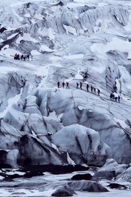 depth with layering for photo composition,how to photograph taken at iceland’s second largest glacier langjökull. i was based at the foot of the mass of ice taking abstract shots of the patterns running through the frozen mass when a group of friendly hikers passed me. i waited in position watched their cautious ascent up the intimidating glacier. when the hikers reached a prime position i took my shot, emphasising the fact that when man and nature co-operate they create a powerful work of art.; people on snow covered mountain