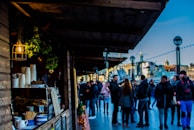 Visitors enjoying a calm moment tasting local herbal teas at a market stall.