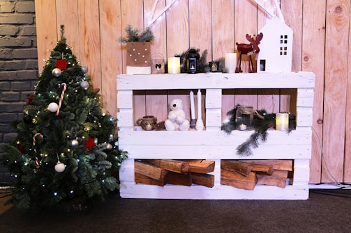 A cozy Christmas scene featuring a beautifully decorated tree surrounded by festive props from Tarrasake LLC.