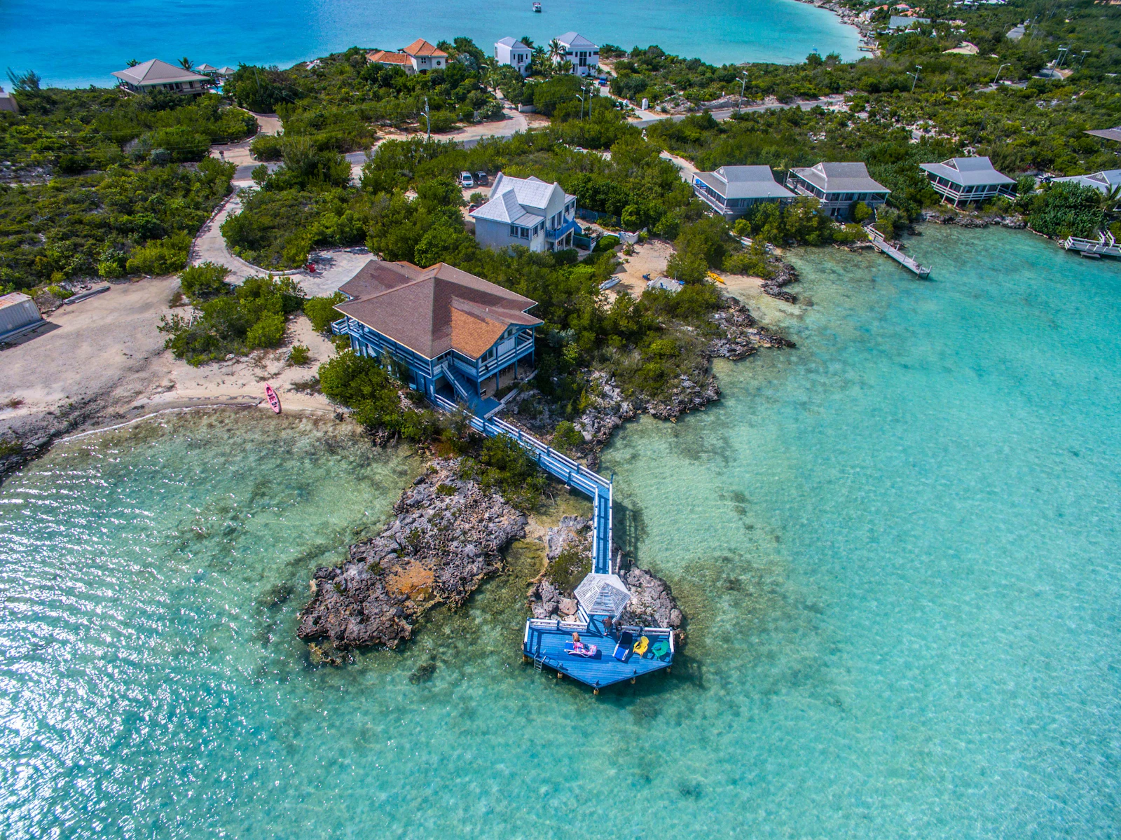 Aerial view of a private waterfront villa with dock in Turks and Caicos