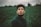 man focus photography of man in green collared top