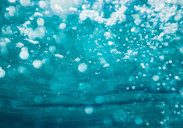 underwater photography of water bubbles
