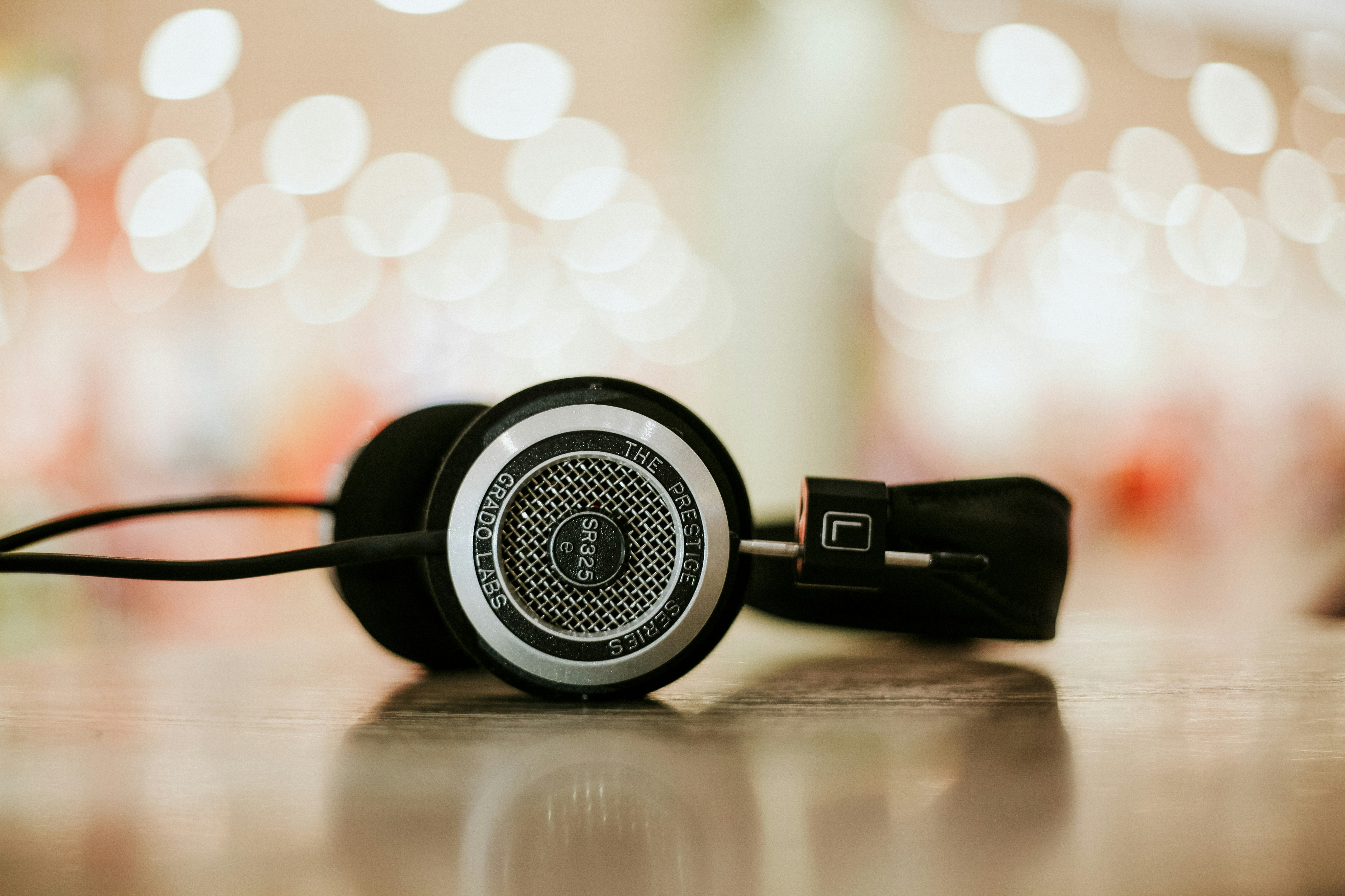 A close-up of headphones on a flat surface with bokeh effect in the background