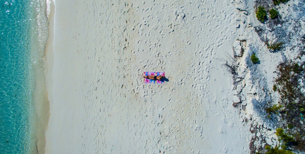 personne prenant un bain de soleil à la plage