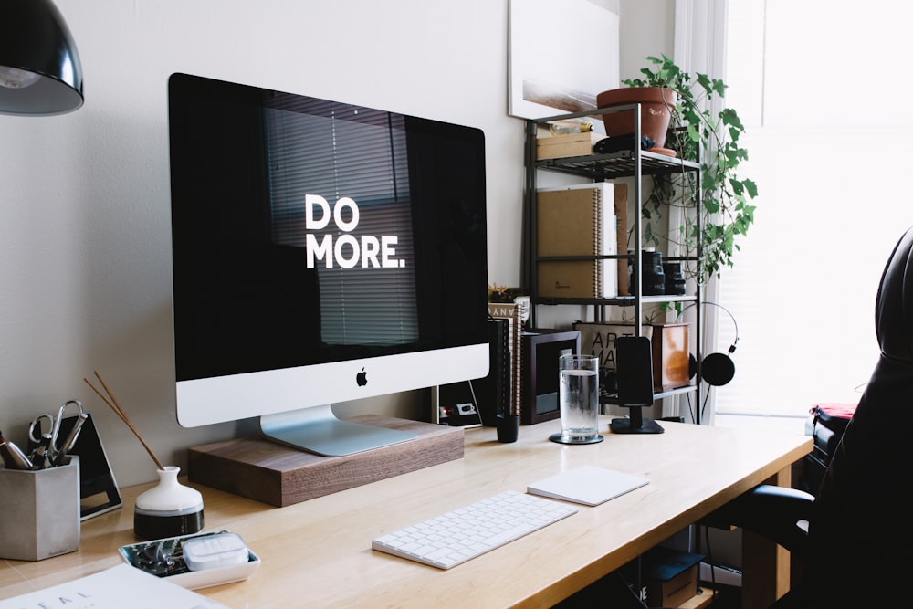 silberner iMac mit Tastatur und Trackpad im Zimmer