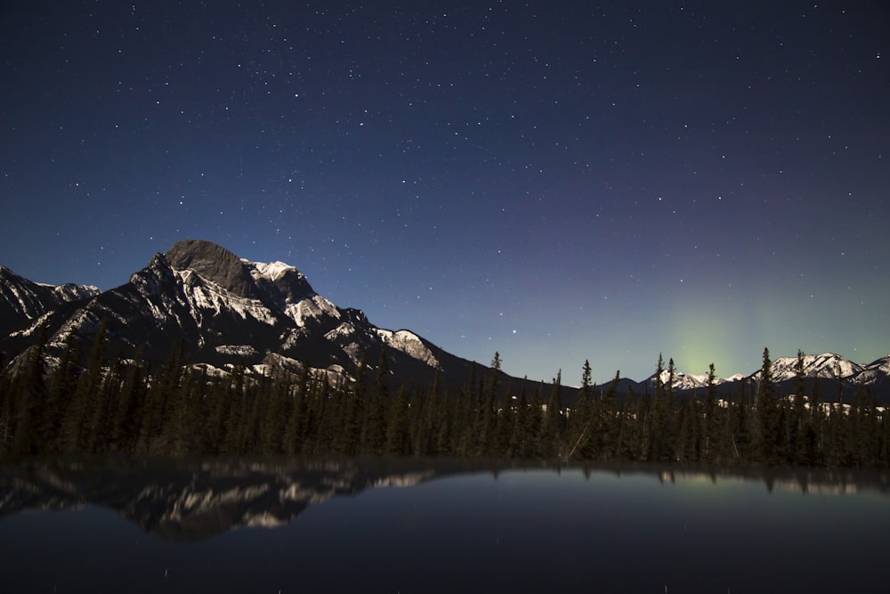 mountain across lake under nighttime