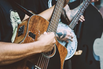 person playing acoustic guitar