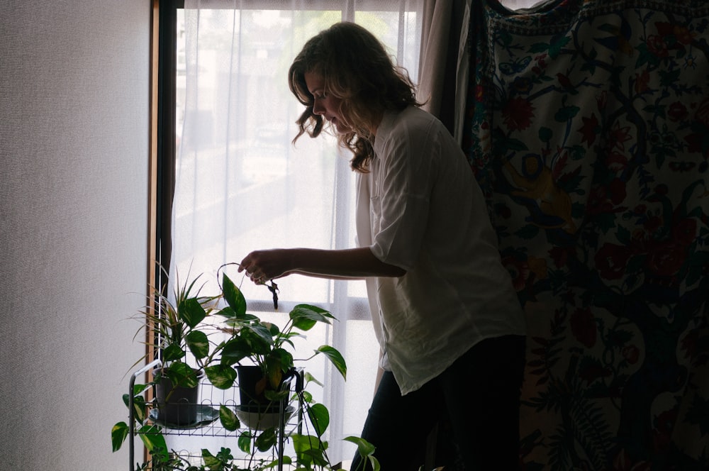 woman standing beside plants