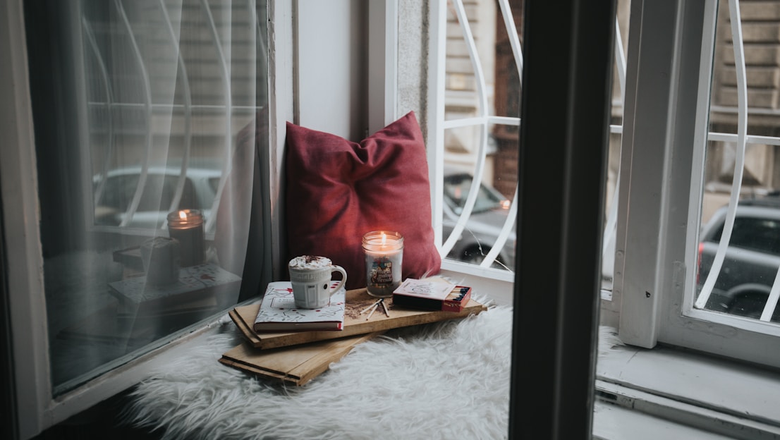 photo of gel candle on board beside pillow