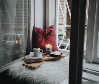 photo of gel candle on board beside pillow