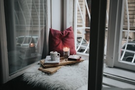 photo of gel candle on board beside pillow