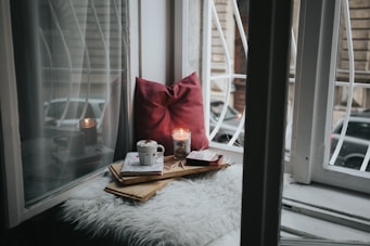 photo of gel candle on board beside pillow