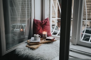photo of gel candle on board beside pillow