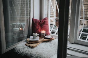 photo of gel candle on board beside pillow