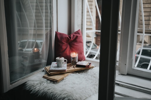 Cozy home staging photo featuring book, coffee mug, and pillow, ideal for real estate listings