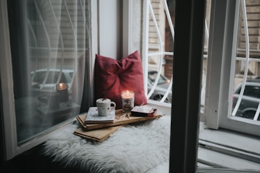 photo of gel candle on board beside pillow