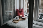 photo of gel candle on board beside pillow