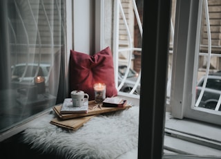 photo of gel candle on board beside pillow