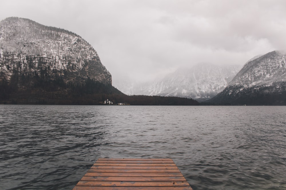 body of water within mountain range during daytime