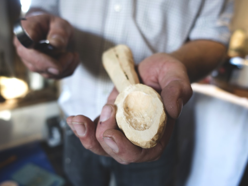 a man holding a piece of bread in his hands