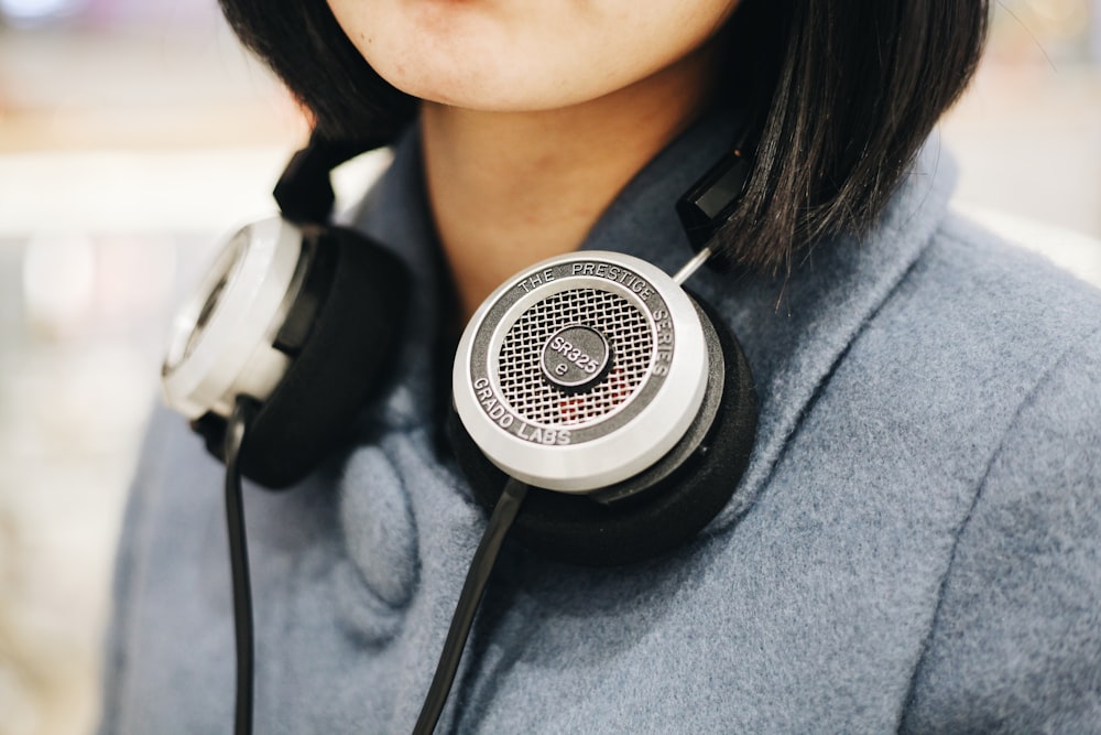 woman with black headphones around her neck