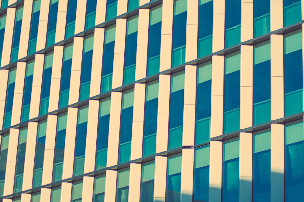 a tall building with lots of windows next to a clock