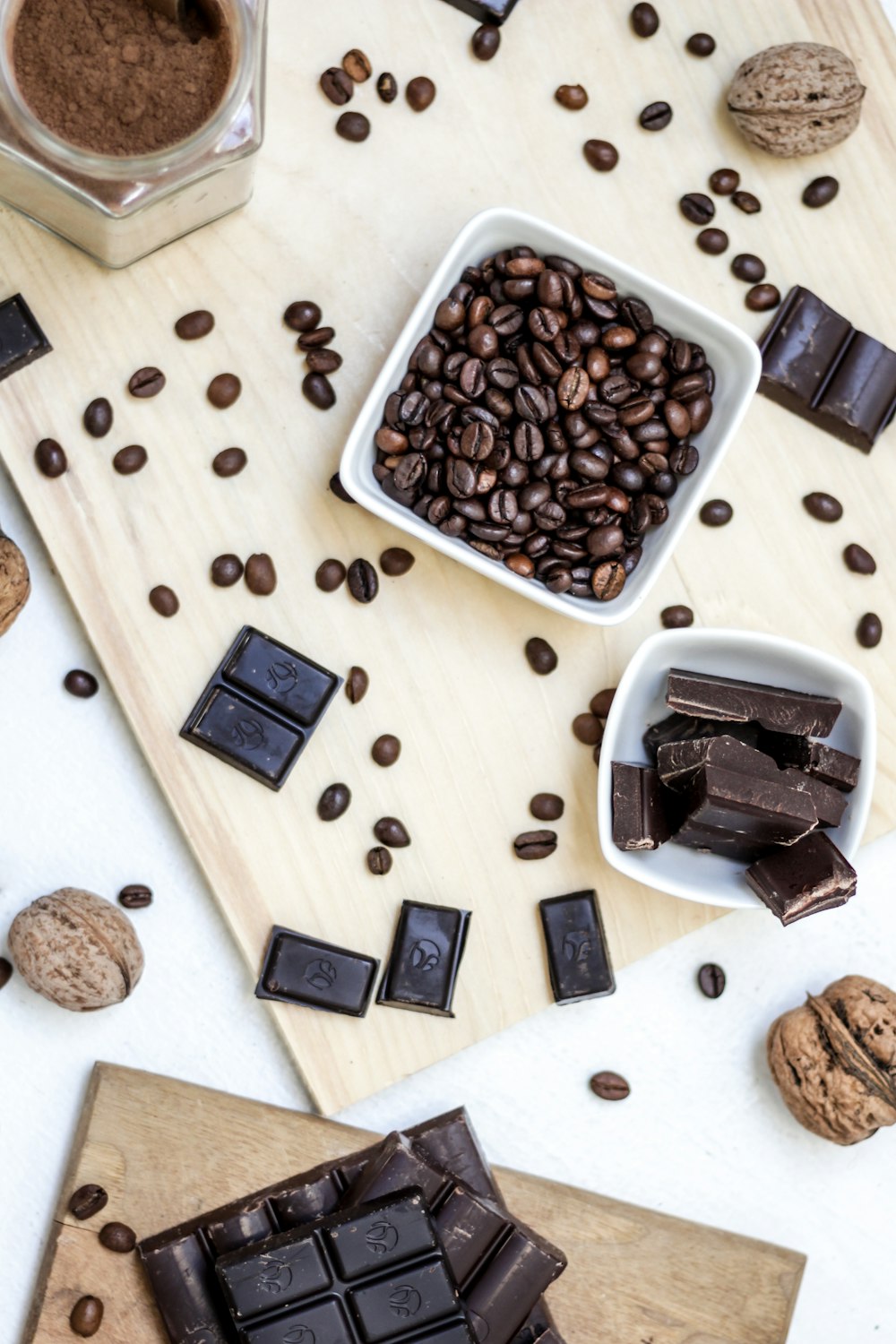 chocolate and coffee seeds on table near bowls