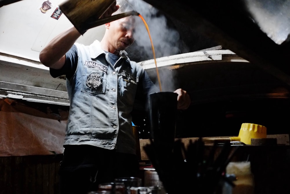 man pouring liquid