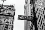 grayscale photo of 1-21 Wall street signage