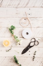 tailoring shears next to spool of brown rope