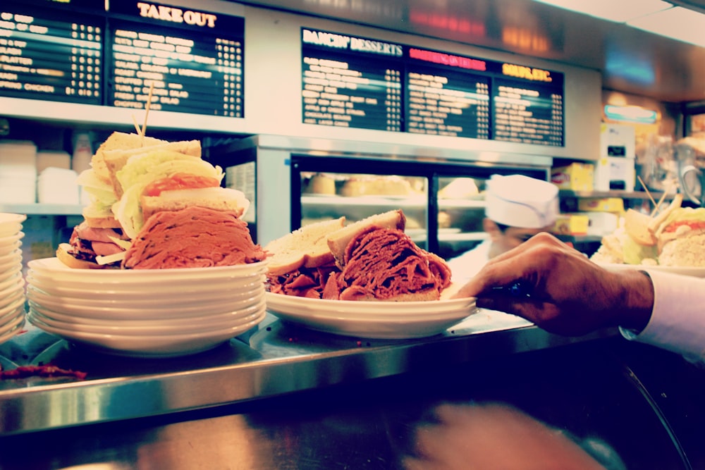 two hearty sandwiches on plate at the counter