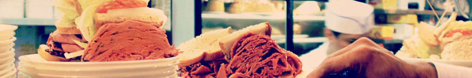 two hearty sandwiches on plate at the counter