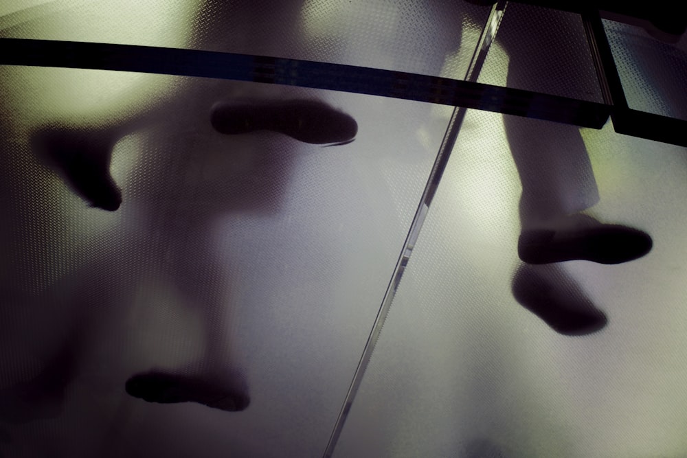 person standing on frosted glass flooring