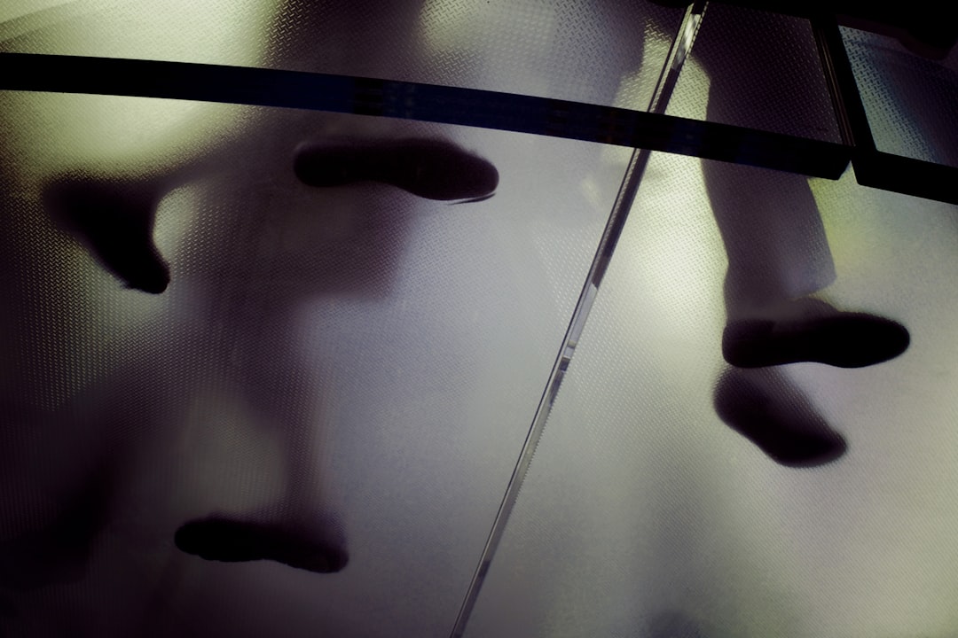 person standing on frosted glass flooring