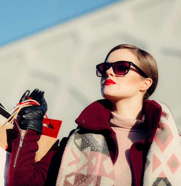 shallow focus photography of woman holding shopping bags during day