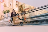woman riding escalator