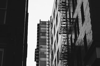 A dramatic urban scene featuring bold monochrome colors with a touch of deep red.