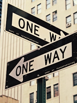 white and black One Way-printed road signages