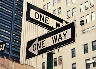 white and black One Way-printed road signages