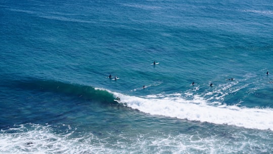 aerial shot of person surfing on ocean in Zuma Beach United States