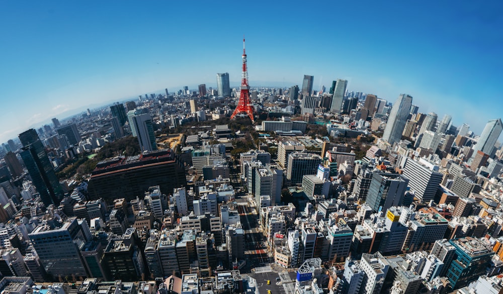 fish eye photography of red and white tower and cityscape
