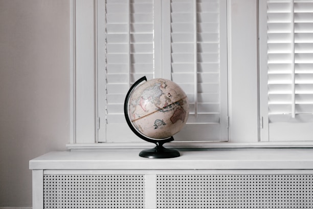 beige desk globe on white desk
