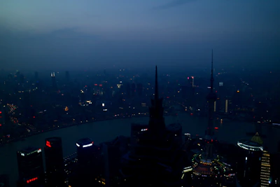 Evening view of a high-rise residential tower lit up against the city skyline.