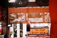 A dark, atmospheric scene of a kami spirit emerging from swirling mist and ink strokes.