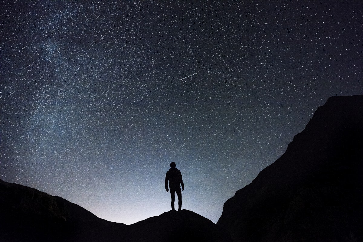 A man staring up at the stars