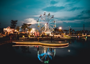 calm body of water near ferris wheel